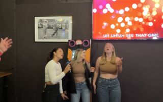 Three girls singing inside a room