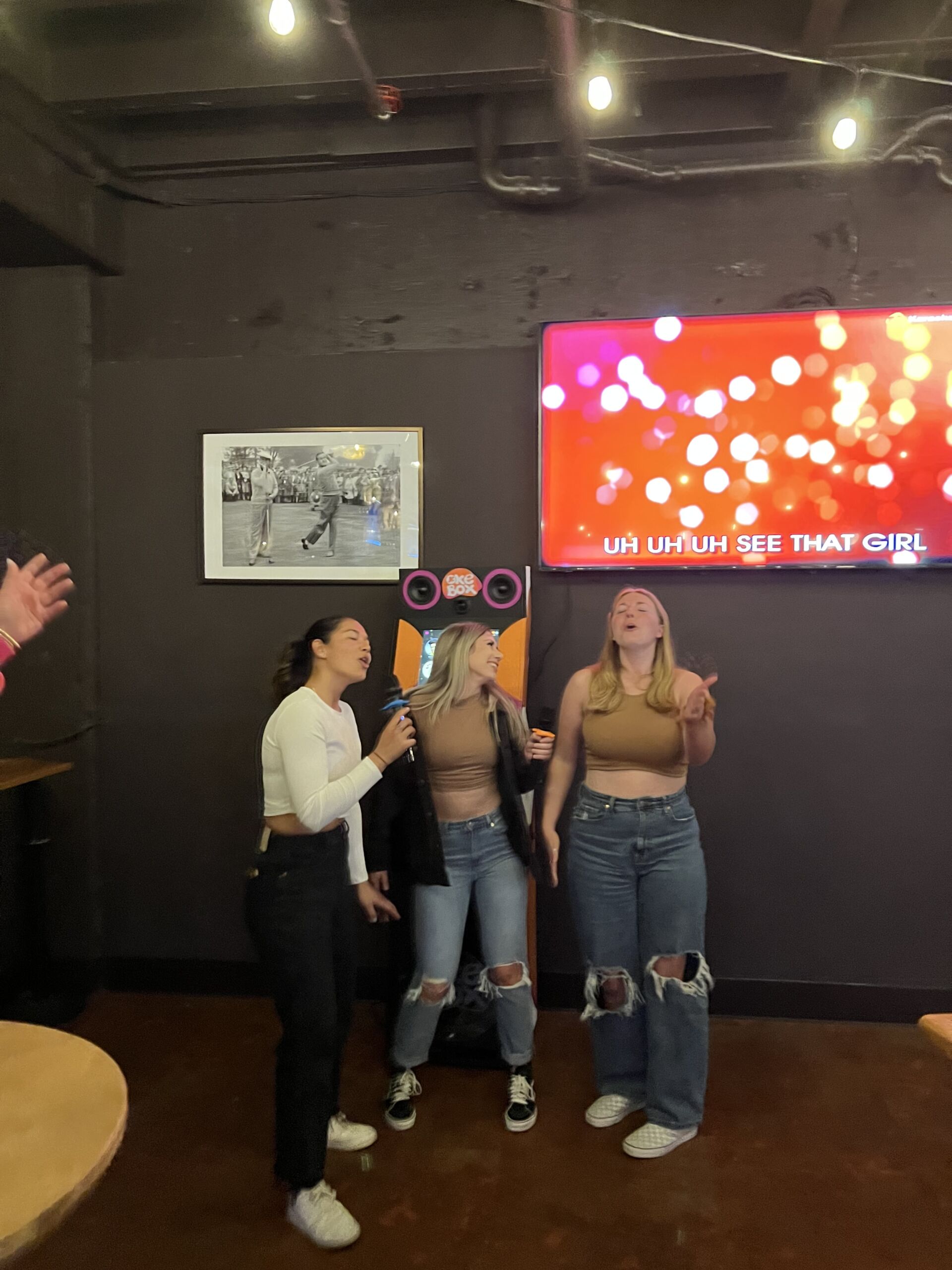 Three girls singing inside a room